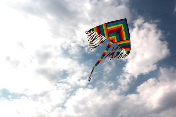 istock view of multicolored kite flying in the sky with clouds 1250298540