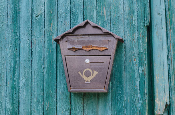 Wood surface. Wooden planks. Old, cracked paint. Mailbox.