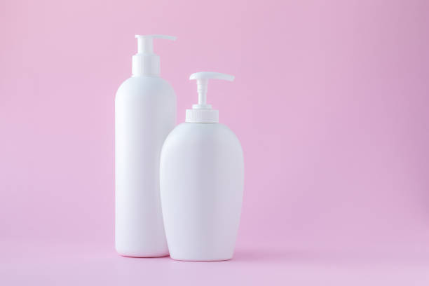 istock Set of cosmetic bottles with dispenser on a pink background. Copy space, empty place for text. Toiletries, pump lotion. Moisturizing cream for body and face. 1250299990