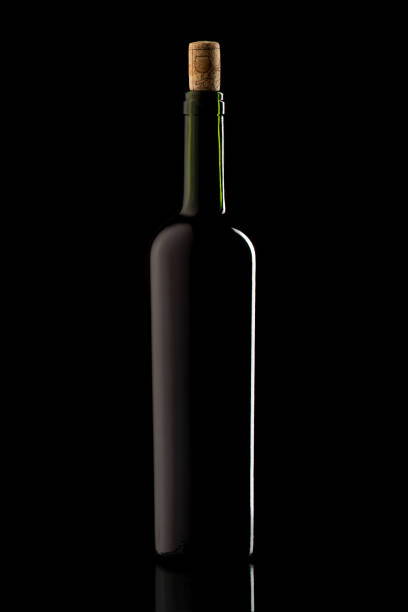 istock Wine bottle with cork and on black isolated background 1250300004