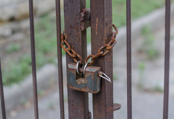 istock Padlock. Iron chain on the fence. Iron gate. 1250300058
