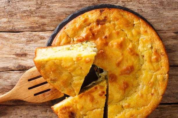 istock Slavic pie stuffed with cabbage, herbs and boiled eggs close-up on a slate board. Horizontal top view 1250300824