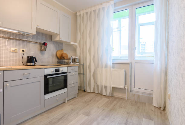 istock Kitchen interior in the apartment. Exit to the balcony and large windows. 1250300838