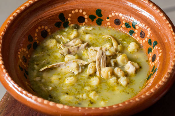 Green Pozole, traditional Mexican cuisine, hominy stew Pozole verde, or green posole is traditionally made with hominy and meat and topped with condiments. Mexican cuisine. tomatillo photos stock pictures, royalty-free photos & images
