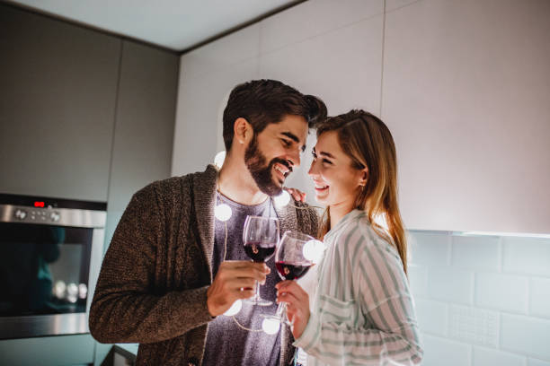 istock Young couple is drinking wine at home 1250301578