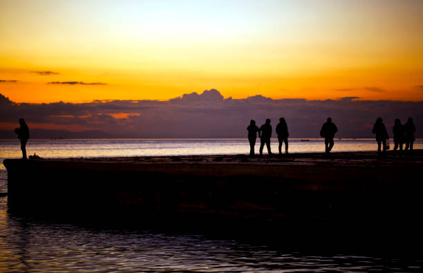 istock Seascape Sunset and People Silhouette 1250302126