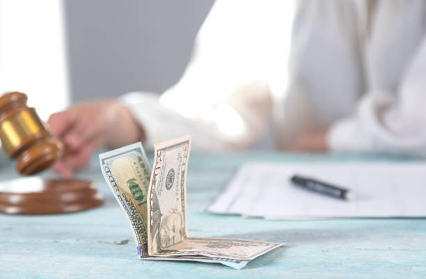 istock judge and money on table 1250304741