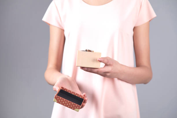 istock woman hand watch on box 1250304777