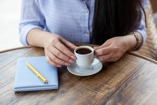 istock woman hand coffee and notepad 1250305391