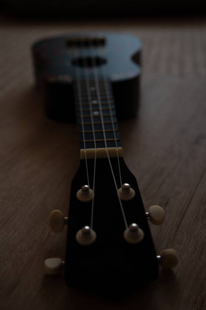 istock Small ukulele guitar on a wooden background 1250305423