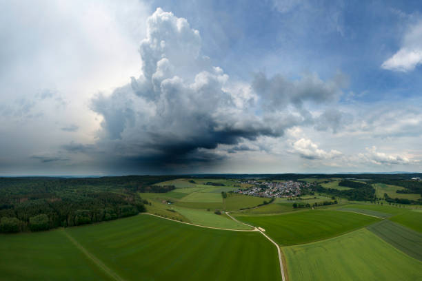 Large approaching thunderstorm cloud - aerial view Large approaching thunderstorm cloud - aerial view approaching stock pictures, royalty-free photos & images