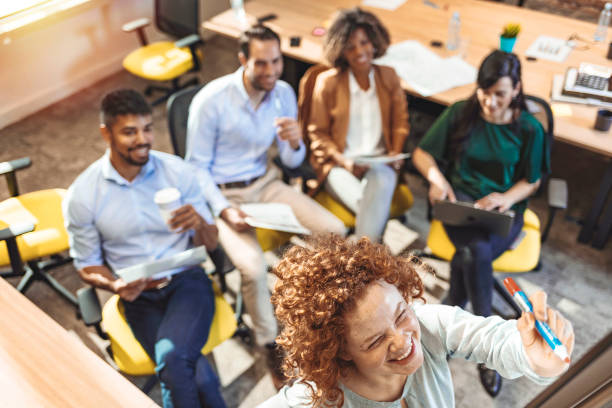 istock Happy group of business people during presentation 1250307239