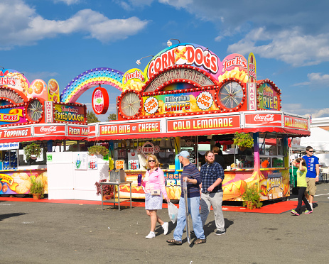 West Springfield, Massachusetts, USA-September 18, 2014- Smiling fairgoers stroll past the colorful food vendors at the annual Eastern States Exposition.