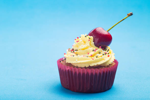 istock Cupcake with whipped cream decorated with a cherry made without lactose 1250307733