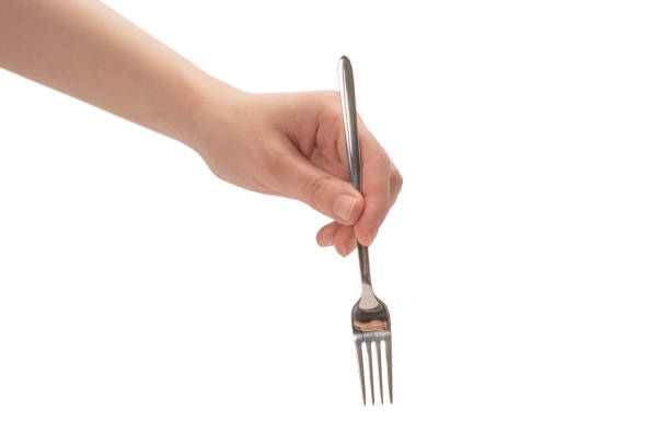 istock Fork in woman hand isolated on white. 1250308395