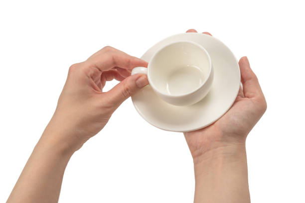 istock Empty coffee cup in woman hand isolated on white. 1250308397