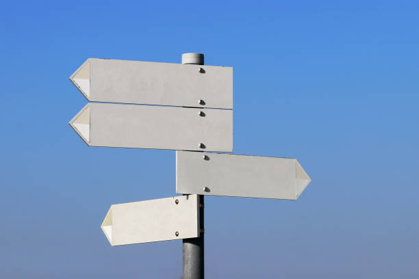 istock Empty directional signs in front of a blue sky 1250308612
