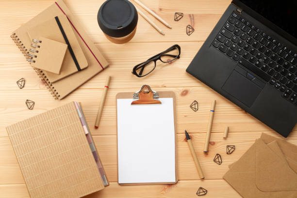istock Top view over working place with laptop and office supplies 1250310941