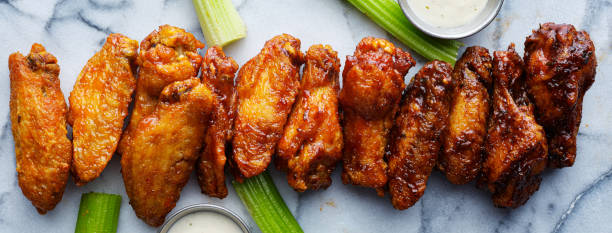 istock line of buffalo chicken wings drenched in different sauces 1250310964