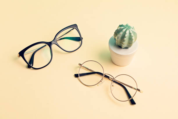 istock Stylish eyeglasses over pastel  background. Optical store, glasses selection, eye test, vision examination at optician, fashion accessories concept 1250311033