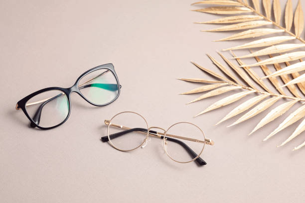 istock Stylish eyeglasses over pastel  background. Optical store, glasses selection, eye test, vision examination at optician, fashion accessories concept 1250311054
