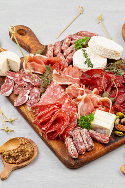 istock Appetizers table with differents antipasti, charcuterie, snacks and wine. Sausage, ham, tapas, olives, cheese and crackers for buffet party. Top view 1250311174