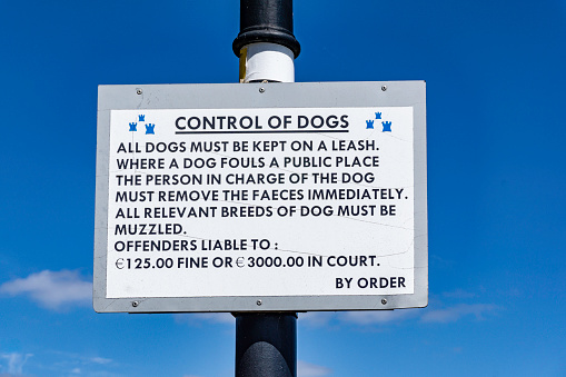 a sign from Dublin City Council in Ireland warning of the consequences of not keeping your dog on a leash.