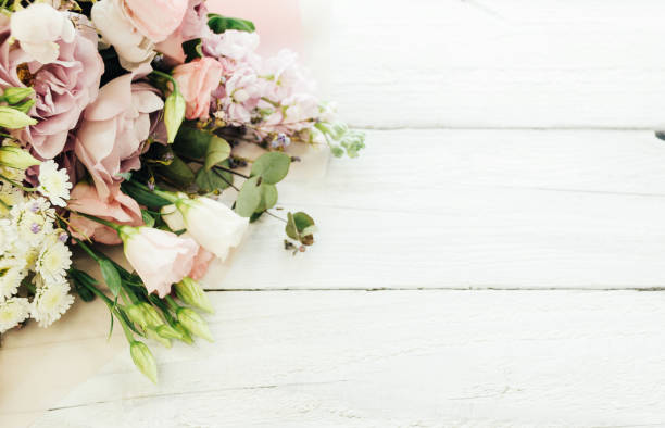 istock a large and beautiful bouquet of fresh roses, eustoma, matiola, freesia, eucalyptus, hydrangea in delicate pink and white colors, on a white wooden background in the style of Provence. Copy space. 1250312252