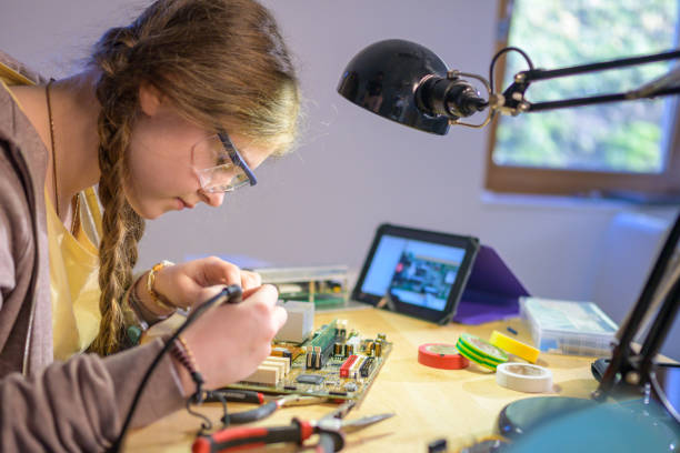 istock Teenage girl soldering while watching a tutorial on a tablet 1250312434