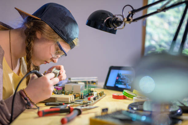 istock Teenage girl soldering while watching a tutorial on a tablet 1250312718