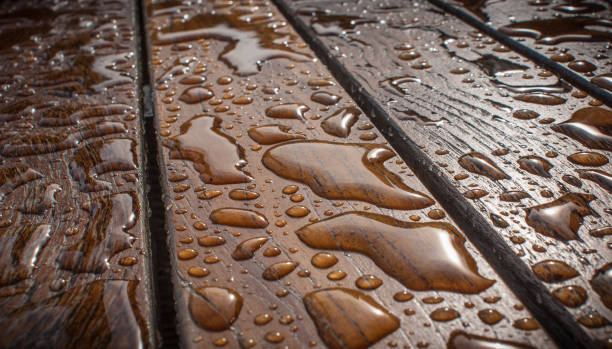 istock Wooden table wet from the rain with waterdrops 1250314137