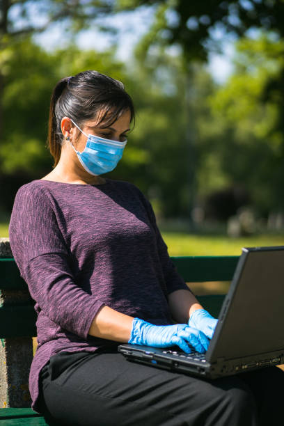 istock young woman using laptop keyboard with gloves on 1250316589
