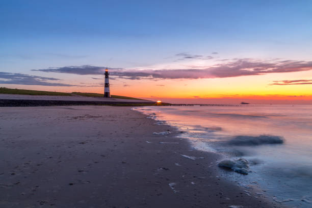 istock Lighthouse guiding the seamen throught the sunset on the gateway 1250317549