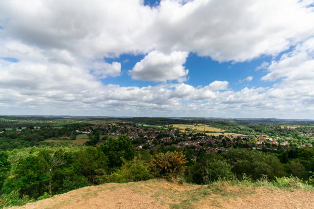 istock Hillside View of Valley Town under Cloudy Blue Sky 1250322533