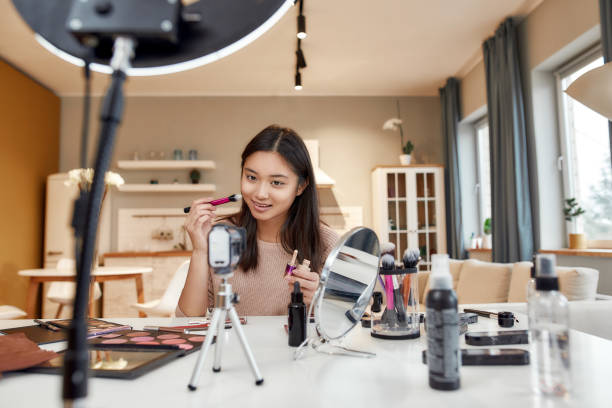 istock The Beauty Authority. Asian female blogger applying makeup while recording a tutorial video for her beauty blog using camera at home 1250322558