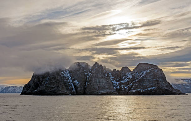 lenticular clouds in the sun over a remote island - baffin island imagens e fotografias de stock