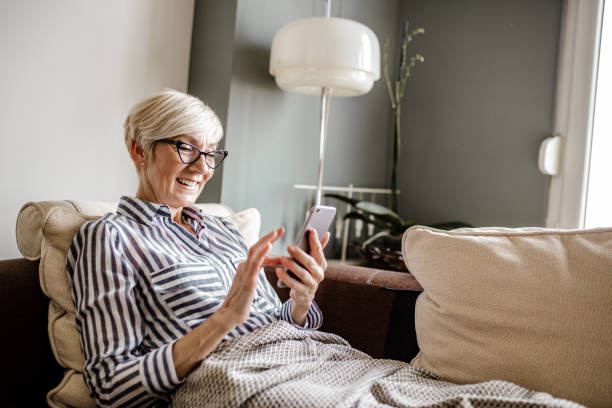 istock Senior woman using mobile phone at home 1250326623