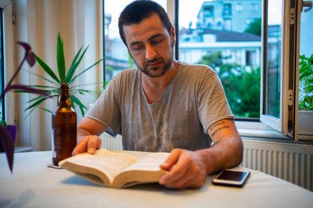 istock man reading with beer in home 1250328895