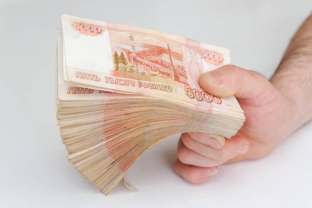 istock Men's hands hold a large number of banknotes 1250329149