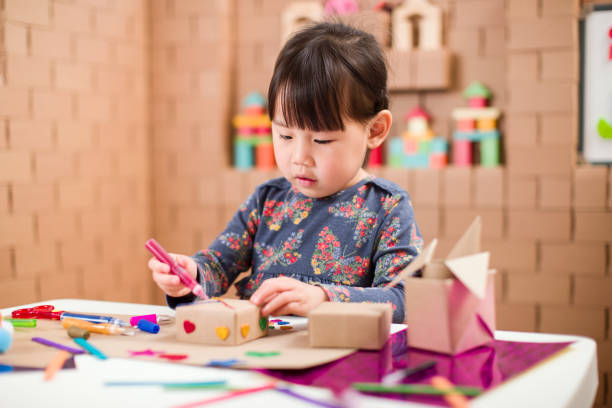 istock toddler girl  making craft by using cardboard for homeschooling 1250329166
