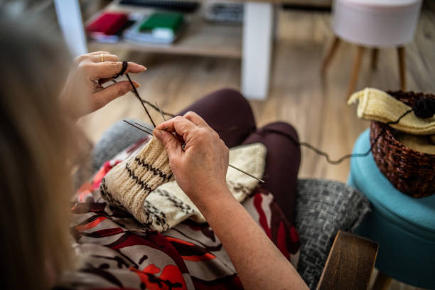 istock An older woman is knitting wool socks 1250331134