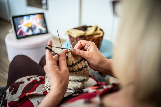 istock An older woman is knitting wool socks 1250331231