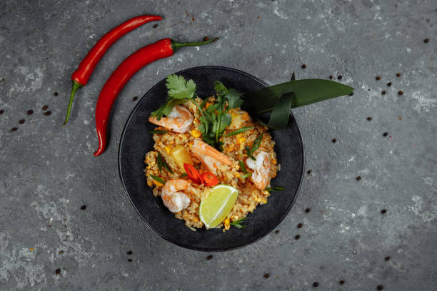 istock Thai rice with shrimp in a black plate on a dark background. copyright place 1250331369