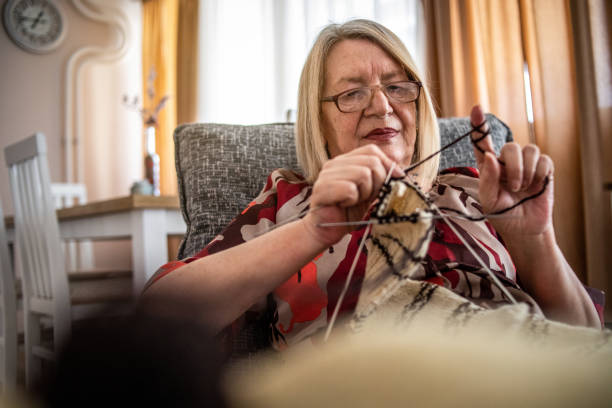 istock An older woman is knitting wool socks 1250332656