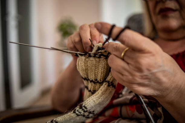 istock An older woman is knitting wool socks 1250333351