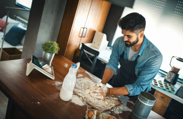 Young men cooking at home.