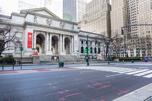 Manhattan, New York, USA - April 5, 2020: Empty streets in front of the New York Public Library on 5th Avenue and 42nd Street due to the COVID-19 pandemic lockdown and stay at home orders in New York.