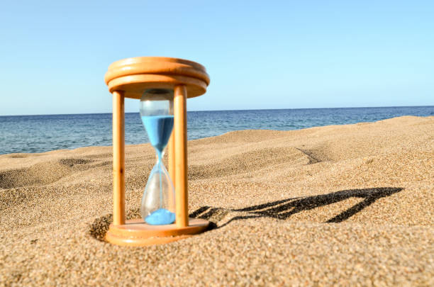 istock Hourglass Clock on the Sand Beach 1250336658