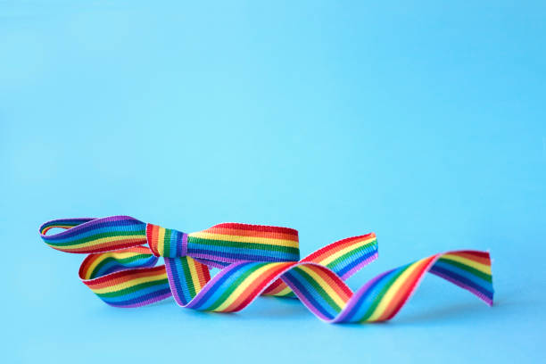istock Rainbow ribbon bow on blue background. Pride concept 1250336820