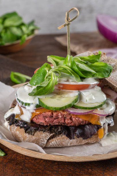 istock Healthy vegan burger with fresh vegetables and yogurt sauce 1250339701